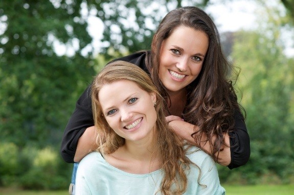 Two young women smiling together outdoors